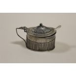 A HALLMARKED SILVER MUSTARD POT AND LINER