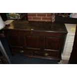 AN ANTIQUE OAK PANELLED MULE CHEST, the original hinged lid above a triple panel front and two