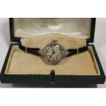 A LADIES VINTAGE PLATINUM AND DIAMOND SET WATCH - EACH BRILLIANT CUT DIAMOND APPROX 0.02 CARATS -