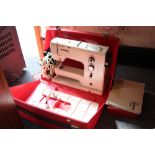 A CASED BERNINA RECORD SEWING MACHINE WITH INSTRUCTIONS