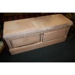 AN UPHOLSTERED PAINTED OTTOMAN WITH DRAWERS