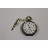 A SMALL ANTIQUE SILVER POCKET WATCH WITH KEY
