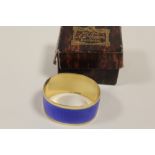 A HALLMARKED SILVER GILT AND ENAMEL NAPKIN RING