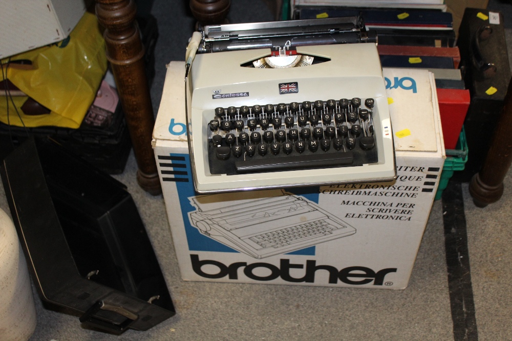 A BOXED BROTHER TYPEWRITER TOGETHER WITH A CONTESSA EXAMPLE