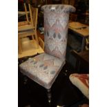 AN ANTIQUE PRIE DEUX CHAIR WITH MODERN UPHOLSTERY