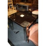 A MODERN BLACK GLASS DINING TABLE 102 X 102 cm