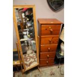 A HONEY PINE TALL FIVE DRAWER CHEST WITH A CHEVAL MIRROR