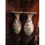 A PAIR OF ORIENTAL BALUSTER VASES WITH FRILLED RIMS, each vase decorated with a figure in a shaped