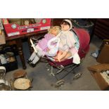 A VINTAGE DOLLS PRAM CONTAINING DOLLS