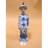 AN ORIENTAL BLUE AND WHITE FIGURE WITH IMPRESSED STAMPS TO BASE