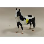 A BESWICK PIEBALD PONY FIGURE