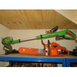 A HUSQVARNA CHAINSAW TOGETHER WITH A CORDLESS STRIMMER