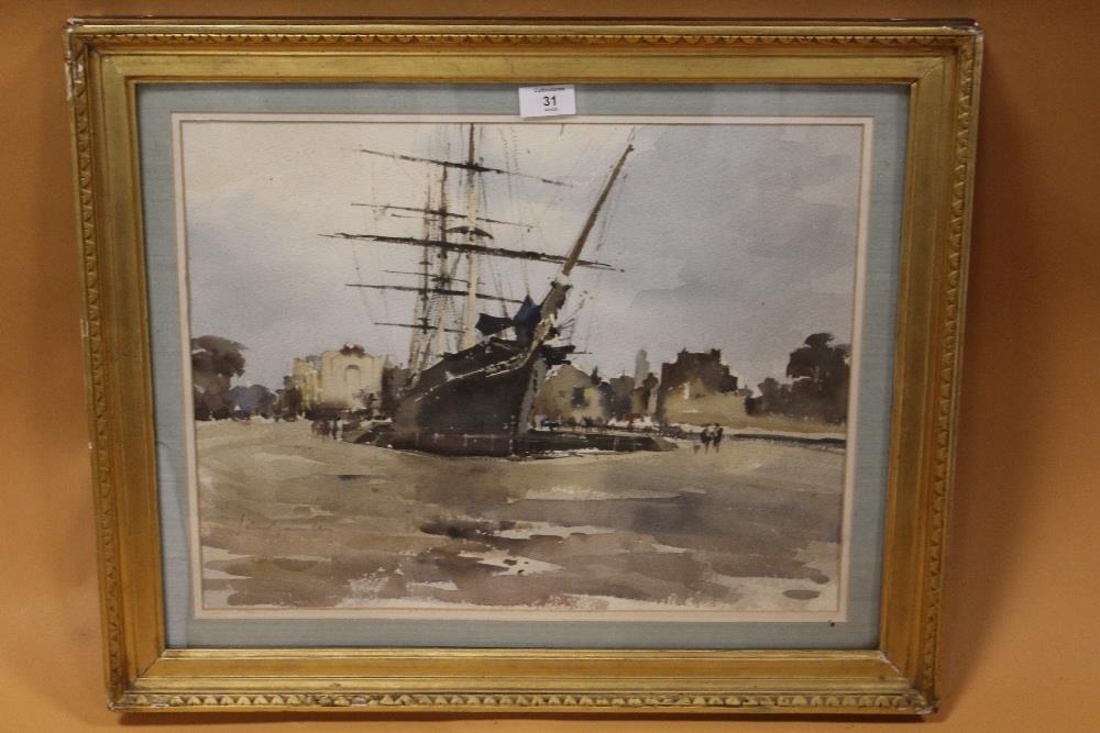 A GILT FRAMED AND GLAZED WATERCOLOUR OF A SAIL SHIP IN DOCK, INDISTINCTLY SIGNED LOWER LEFT