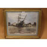 A GILT FRAMED AND GLAZED WATERCOLOUR OF A SAIL SHIP IN DOCK, INDISTINCTLY SIGNED LOWER LEFT