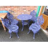 A HEAVY CAST IRON PURPLE PAINTED PATIO SET COMPRISING OF TABLE AND FOUR CHAIRS