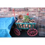 A VINTAGE PAINTED WOODEN CART CONTAINING A LARGE QUANTITY OF PLANT POTS