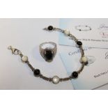 A BLACK ONYX AND SILVER DRESS RING TOGETHER WITH A SIMILAR BRACELET WITH CERTIFICATES