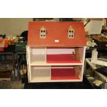 A VINTAGE WOODEN DOLLS HOUSE