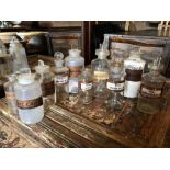 A COLLECTION OF TEN LATE 19TH / EARLY 20TH CENTURY GLASS APOTHECARY / CHEMISTS BOTTLES, ALL WITH
