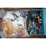 A TRAY OF VINTAGE MARBLES, TRADING CARDS ETC.