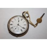 A SMALL ANTIQUE SILVER POCKET WATCH WITH KEY