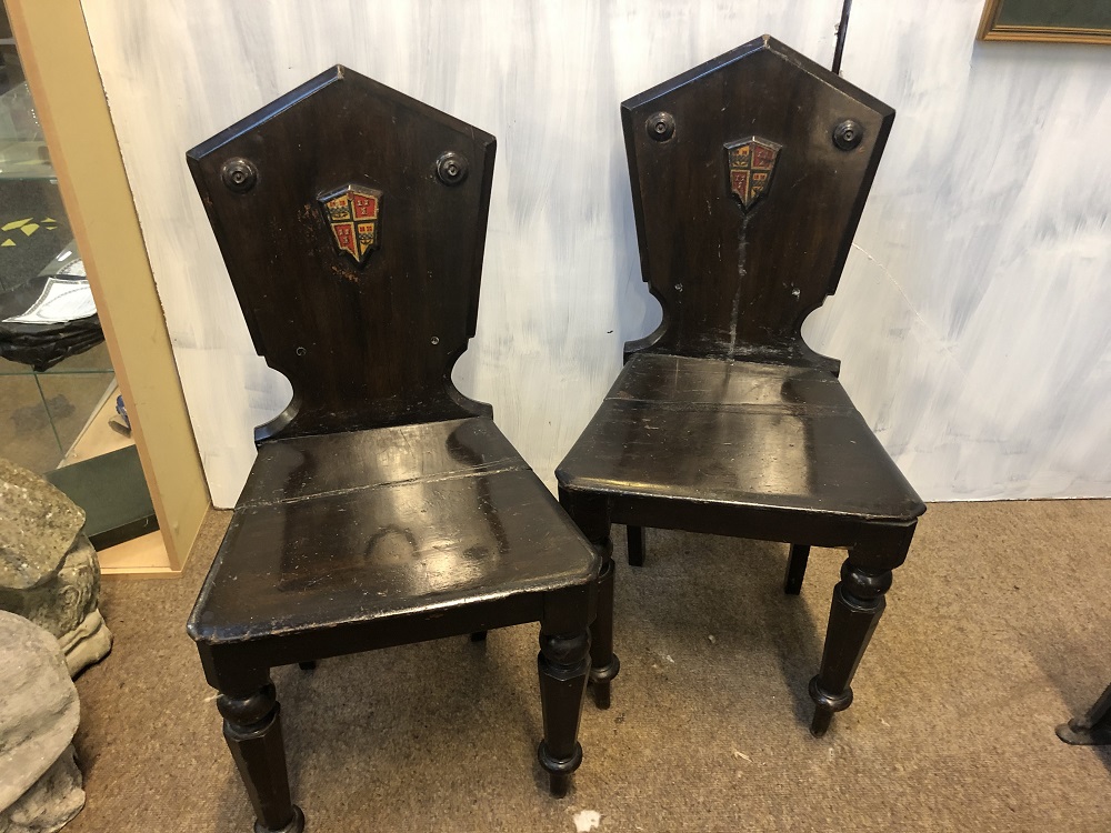 A PAIR OF REGENCY ARMORIAL HALL CHAIRS CIRCA 1820, BOTH WITH ORIGINAL PAINTED GILT ARMORIAL
