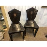 A PAIR OF REGENCY ARMORIAL HALL CHAIRS CIRCA 1820, BOTH WITH ORIGINAL PAINTED GILT ARMORIAL