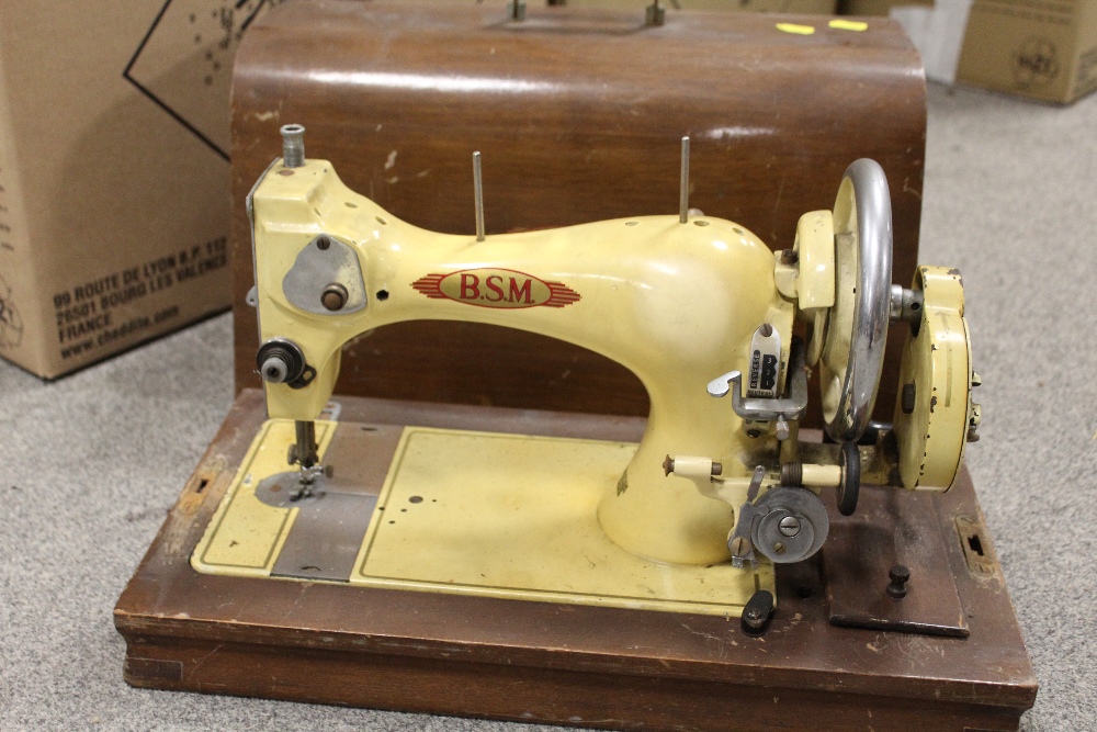 A CASED VINTAGE BSM SEWING MACHINE