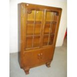 AN OAK GLAZED BOOKCASE