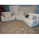 A FABRIC THREE PIECE SUITE COMPRISING TWO TWO SEATER SOFAS AND A CHAIR