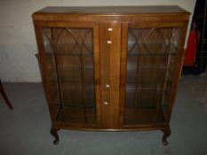 A BOWED CHINA CABINET