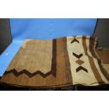 A VINTAGE BROWN AND CREAM KILIM RUG