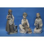 TWO NAO FIGURES AND A LLADRO FIGURE WITH PUPPY (3)