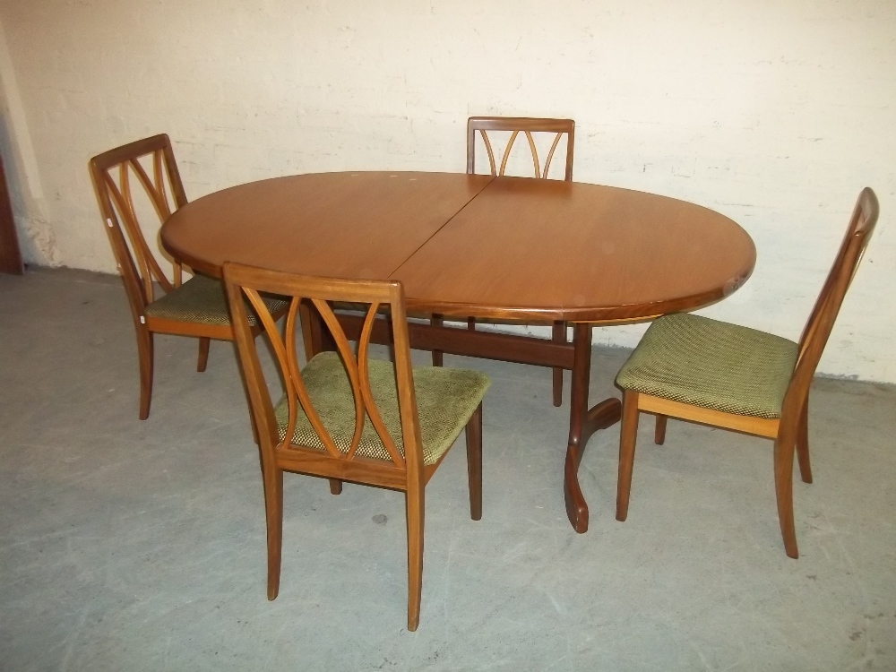 AN EXTENDING TEAK OVAL DINING TABLE AND FOUR CHAIRS MADE BY G-PLAN