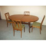 AN EXTENDING TEAK OVAL DINING TABLE AND FOUR CHAIRS MADE BY G-PLAN