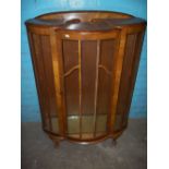 A WALNUT BOW FRONTED CHINA CABINET