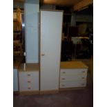 A THREE PIECE MODERN BEDROOM SUITE COMPRISING A SINGLE DOOR WARDROBE, AND TWO THREE DRAWER CHESTS