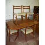 AN OAK EXTENDING DINING TABLE WITH FOUR CHAIRS