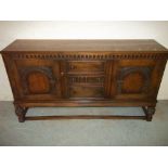 A HEAVY CARVED SOLID OAK SIDEBOARD WITH PINEAPPLE STYLE LEGS