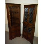 TWO EXCEPTIONAL OAK CORNER UNITS WITH LEADED GLASS AND LINEN FOLD DESIGN DOORS