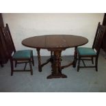 AN OAK DROP LEAF DINING TABLE WITH TWO CHAIRS