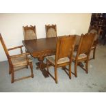 A LARGE OAK DRAW LEAF DINING TABLE AND SIX CHAIRS