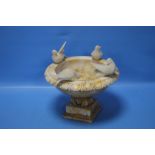 AN ALABASTER BIRD BATH ORNAMENT