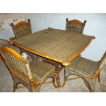 A WICKER DINING TABLE AND FOUR CHAIRS