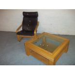 A BROWN LEATHER IKEA POANG CHAIR AND AN OAK COFFEE TABLE