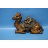 AN ANTIQUE COLD PAINTED INKWELL IN THE FORM OF A CAMEL WITH SADDLE