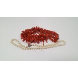 A PEARL NECKLACE WITH SILVER CLASP ALONG WITH A STICK CORAL NECKLACE