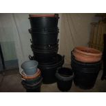A LARGE QUANTITY OF BUCKETS AND LARGE GARDEN PLANTERS