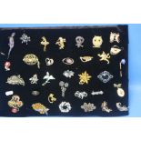 A PAD OF APPROXIMATELY 33 BROOCHES