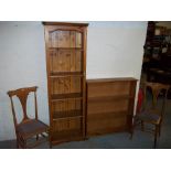 A TALL NARROW PINE BOOKCASE, TWO CHAIRS, A PIANO STOOL AND A LOW WIDE PINE BOOKSHELF